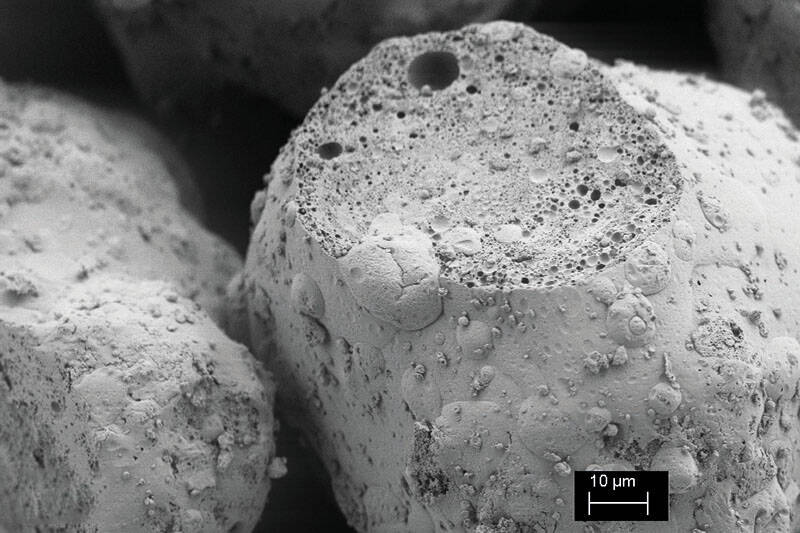 Fig.5: REM-picture of a cut granule with microencapsulated oil. Caption: Glatt